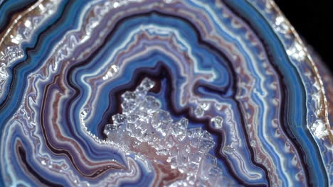 close-up of a polished agate slice showing intricate banding and crystal inclusions