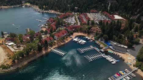 aerial orbital shot looking down at quaint lakeside mountain village. 4k
