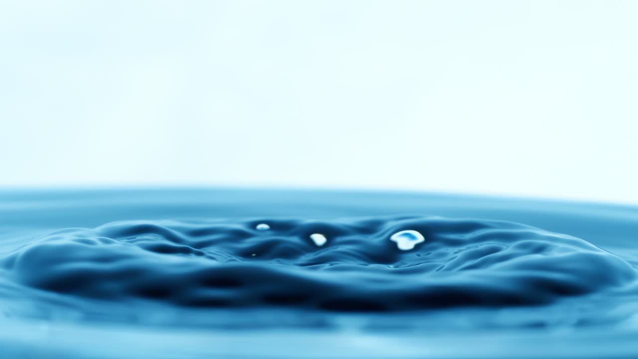 Drop of water falls into a drop of water in a super slow motion. Shot on super slow motion 1600 fps