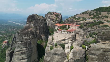 meteora monastery in thessaly, greece mainland - popular tourist attraction and unesco site - aerial 4k pedestal