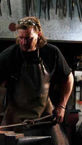 blacksmith working on a iron rod