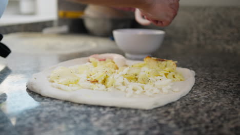 professional chef preparing a pizza with octopus in the restaurant kitchen