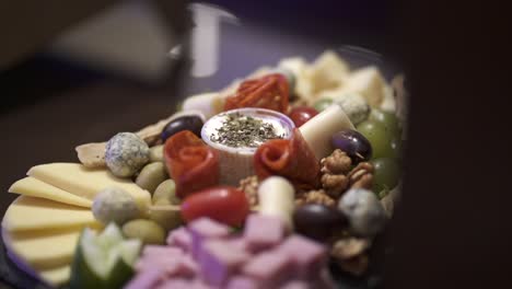 Close-up-of-a-variety-of-cheeses-with-other-starters-make-up-the-elegant-appetizer-platter,-perfect-for-business-dinners,-weddings-or-any-special-event