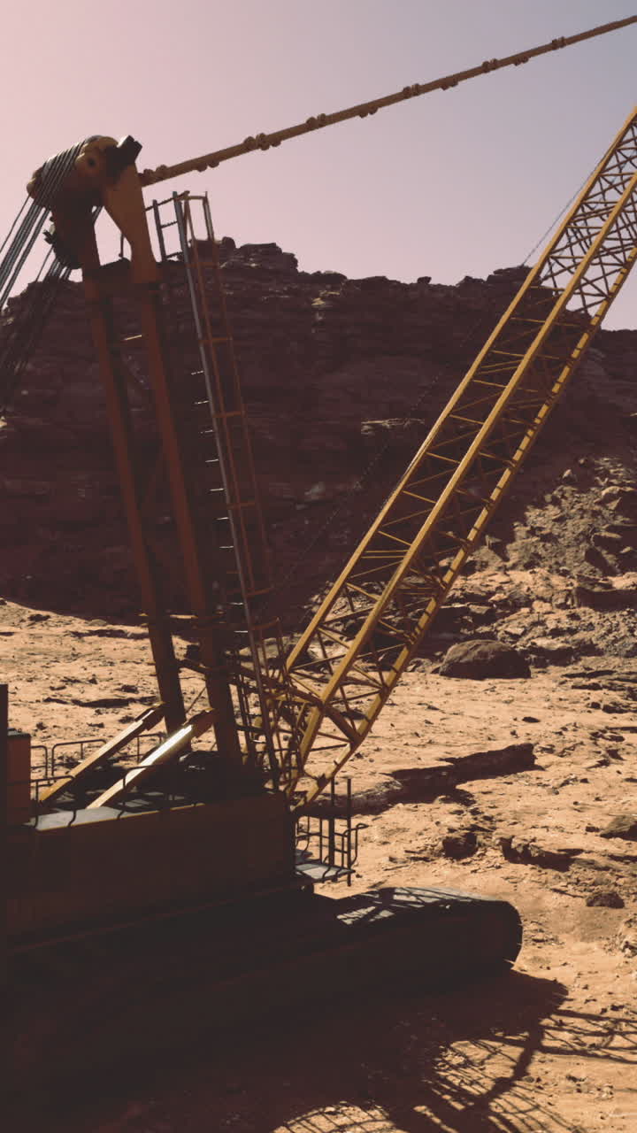 Excavator working in a barren desert landscape during golden hour light