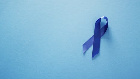 video of blue pancreatic cancer awareness ribbon on blue background with copy space