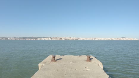 watching lisbon from almada peer shore side, watching over lisbon bay area in portugal