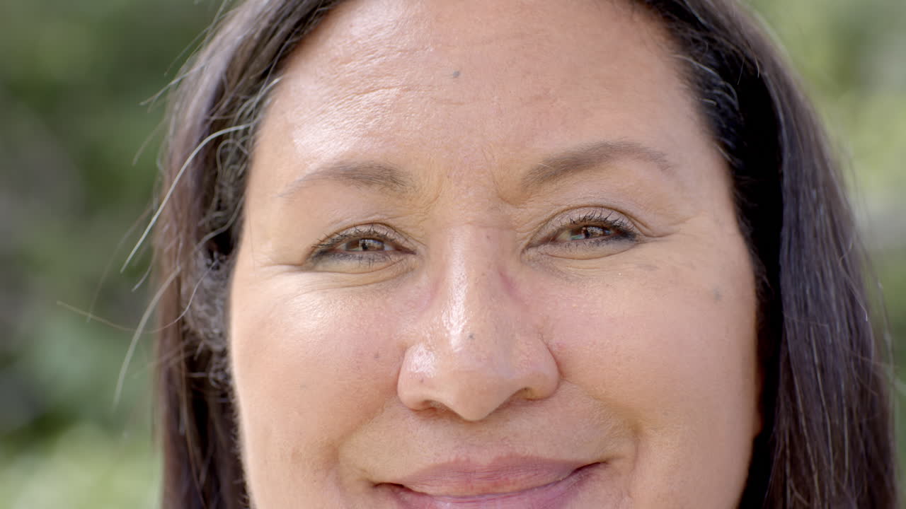 In garden, thoughtful senior woman experiencing peaceful moment in nature