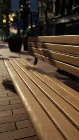 wooden park bench in city street