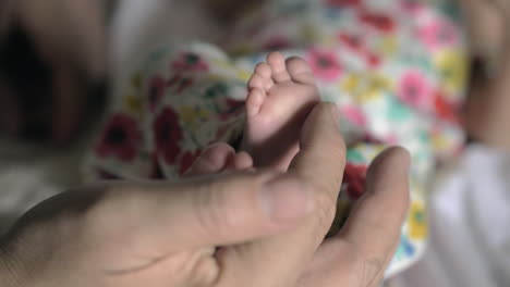 grandpa touching baby feet