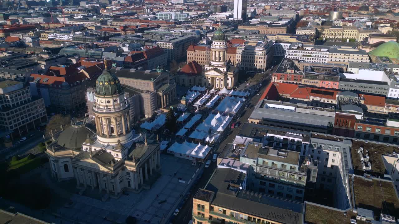 luxury Christmas market tents and historic buildings in Berlin Gendarmenmarkt. Nice aerial view drone fly reverse drone