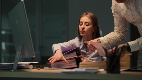 overtime work in the office: professionals handling documents and files
