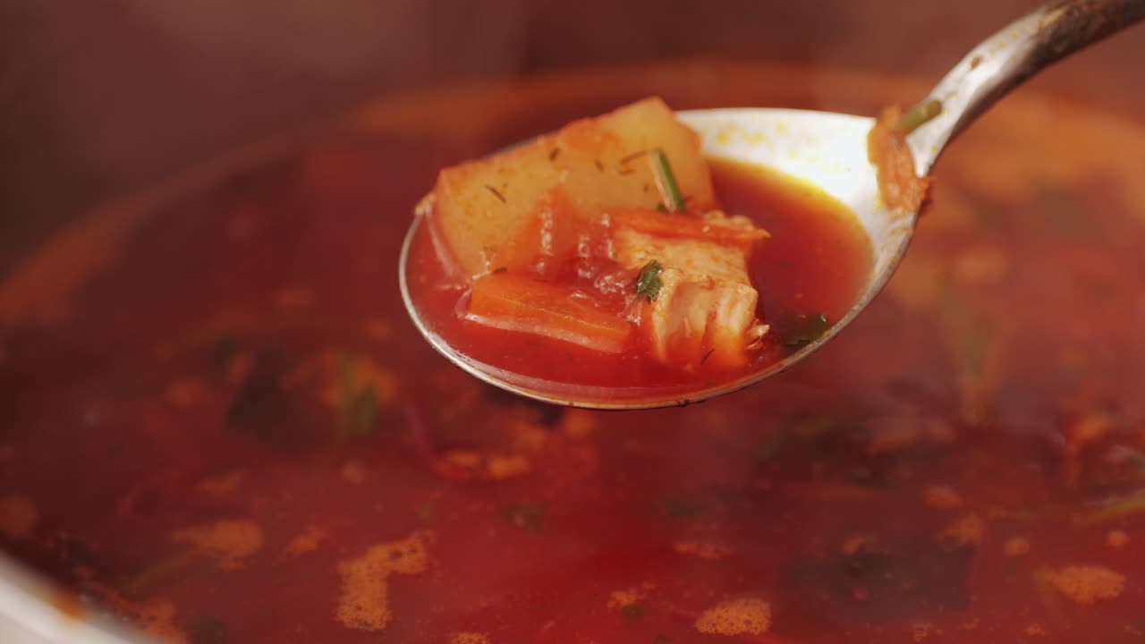 Beetroot soup, Cooking traditional national Russian, Ukranian soup Borsch close-up. Boiling red soup with vegetables and turkey meat and spices. Special red for Borsh from beet, tomatoes pasta