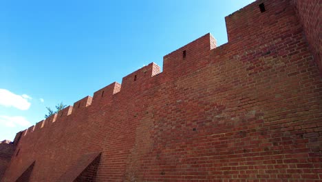 Old-Brick-Wall-Structure-Of-Warsaw-Barbican-Against-Blue-Sky