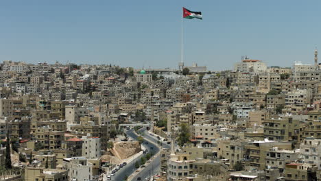 panorama view for the city of amman, jordan with flag from jabal al qal'a, the citadel of amman. 4k
