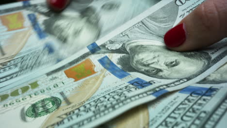 unknown businesswoman counting dollar banknotes in hands. woman receiving salary