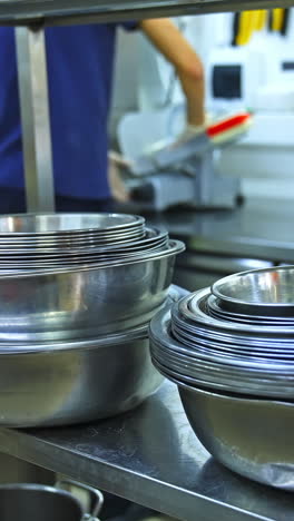 stacked stainless steel bowls in commercial kitchen