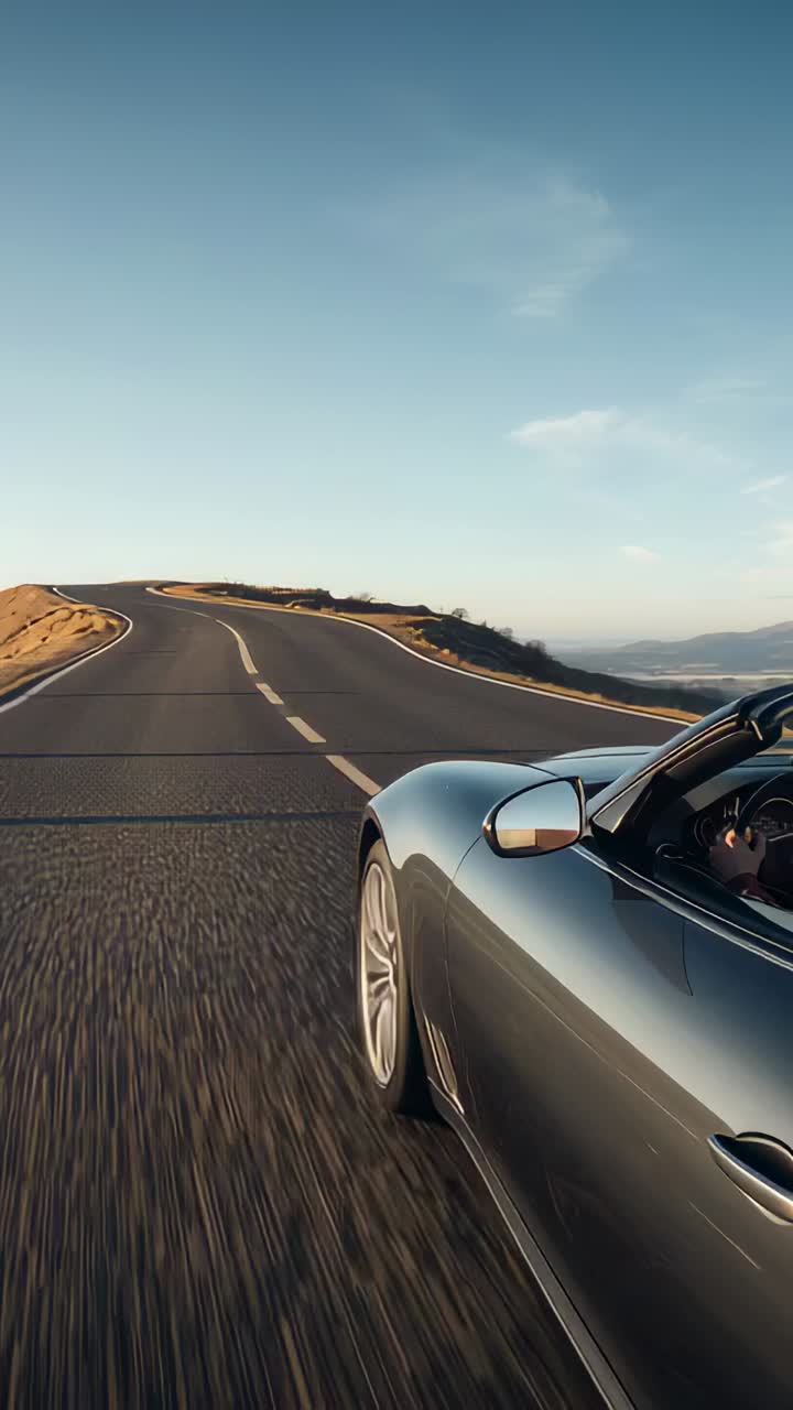 Vertical video: Tracking sports car taking left curve, driver in dark clothes at wheel, copy space