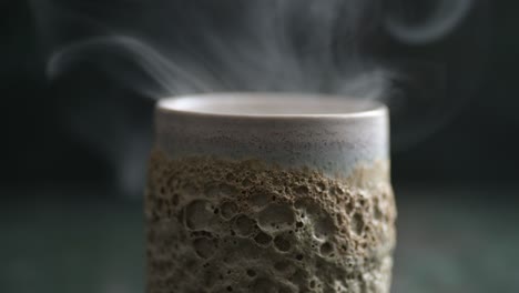 close-up of a lot of flowing smoke over a ceramic glass