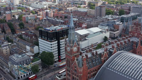 Aerial-footage-of-nice-historic-red-brick-building-with-clock-tower.-St-Pancras-train-station-in-Camden-borough.-London,-UK