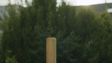 driving a wooden post with a mallet