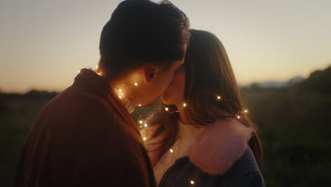 couple kissing outdoors at night