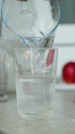 pouring water into a glass