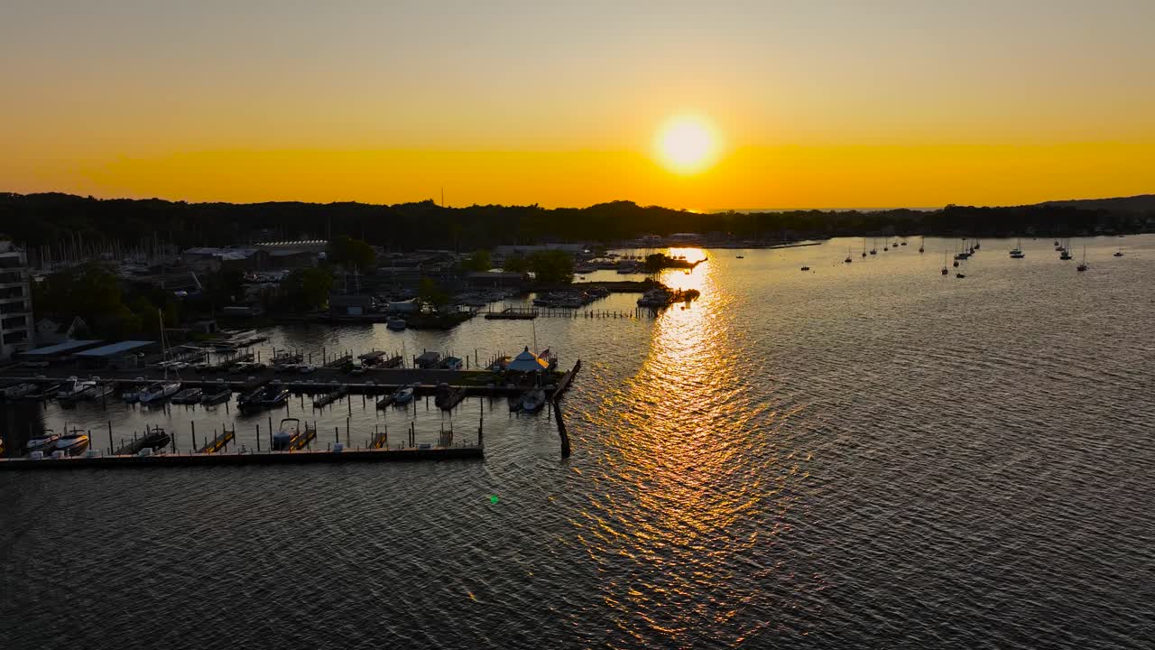 Sun setting in brilliant yellows over several marinas and docks
