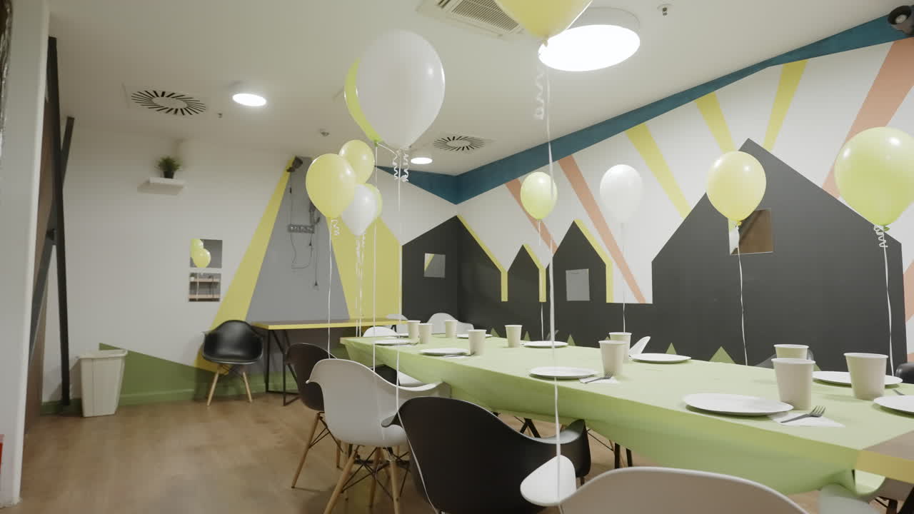 Decorated Party Room with Balloons and Table Settings