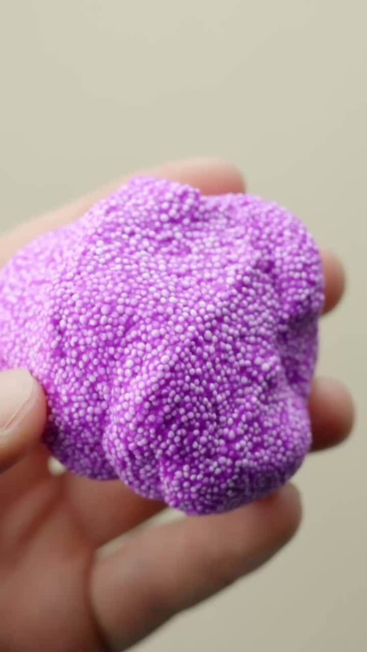 Hands knead violet Floam-Slime in close-up, a fun ASMR sensory toy loved by kids