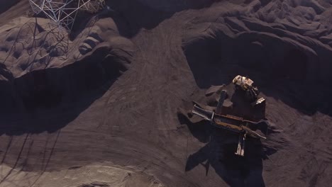 industrial loader unloads petroleum coke on conveyor belt at zug island in detroit, michigan, usa