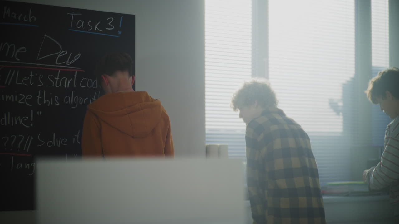 Students in Sun Filled Classroom Discuss Game Development Projects