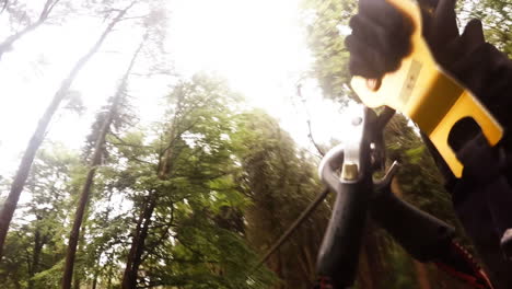 man on zip line in forest