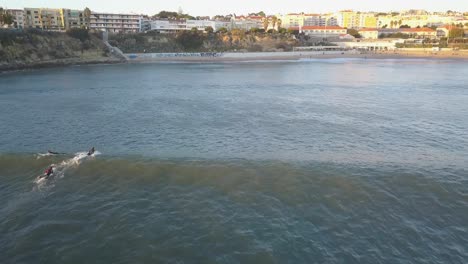 Multiple-surfers-attempting-to-catch-waves-without-success-at-a-pointbreak-in-Portugal