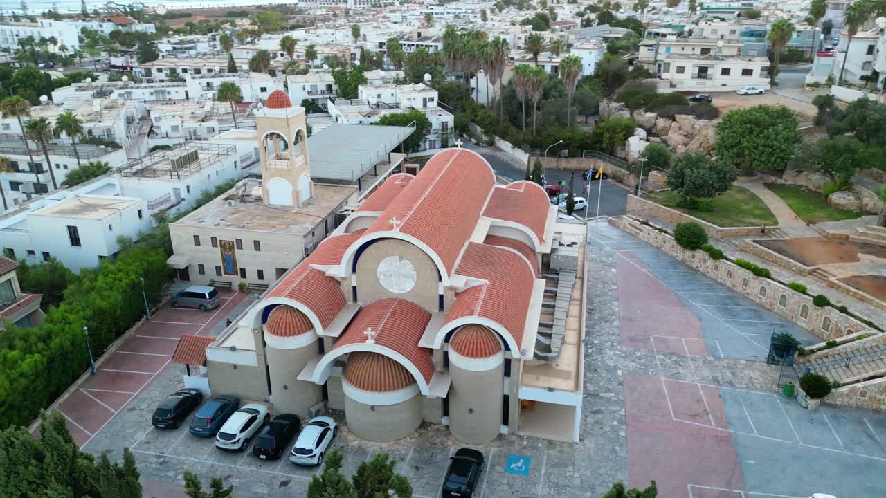 Aerial View Of Church Of Ayia Napa In Cyprus - Red-tiled Domes, Bell Tower, And Stone Courtyard. orbiting shot