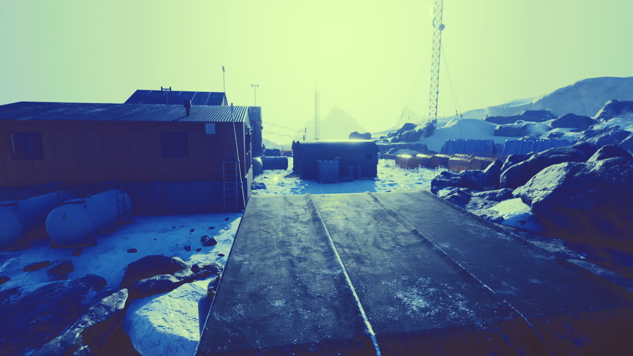 Remote research station in icy landscape under bright sun