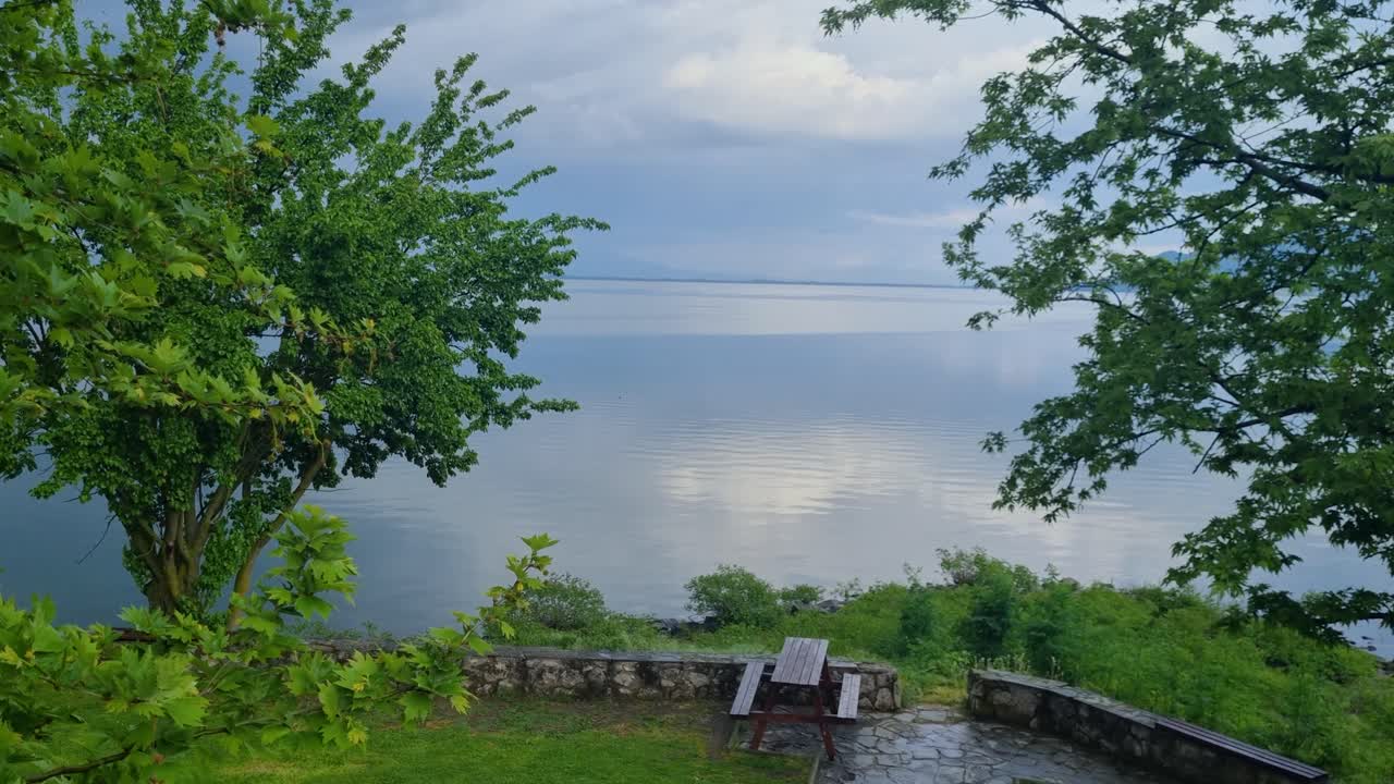 Elevated view of a picknick area at Kerkini Reservoir Lake in northern Greece on a cold spring day, the water lies still under a cloudy spring sky