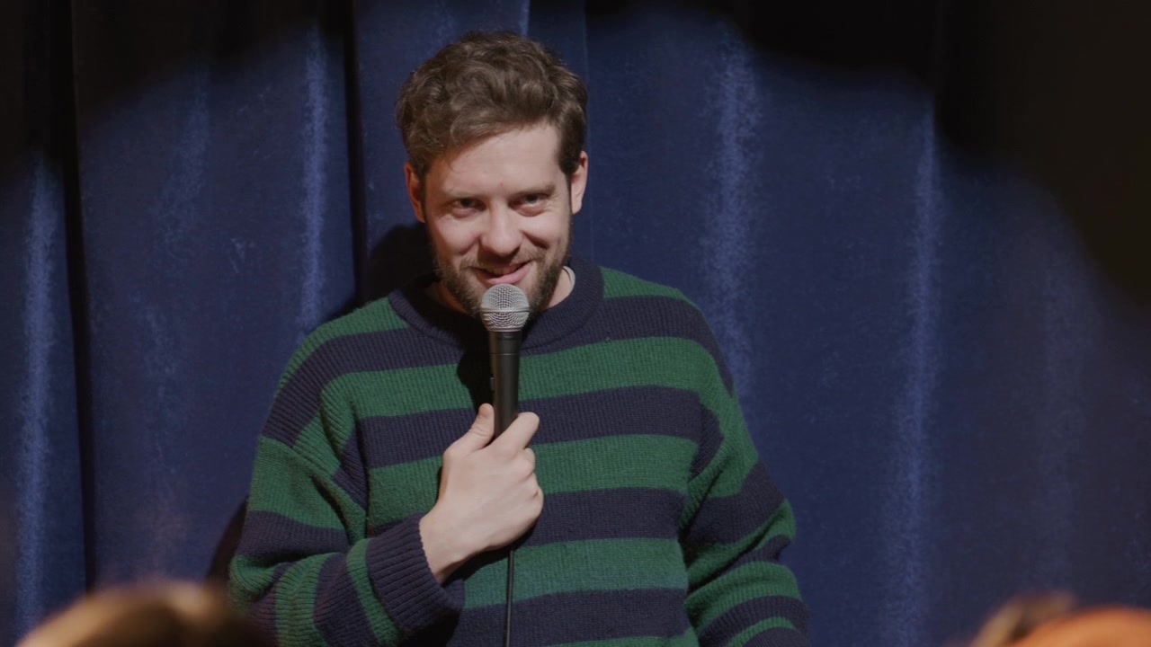 Young Male Comic Telling Jokes and Interacting with Audience
