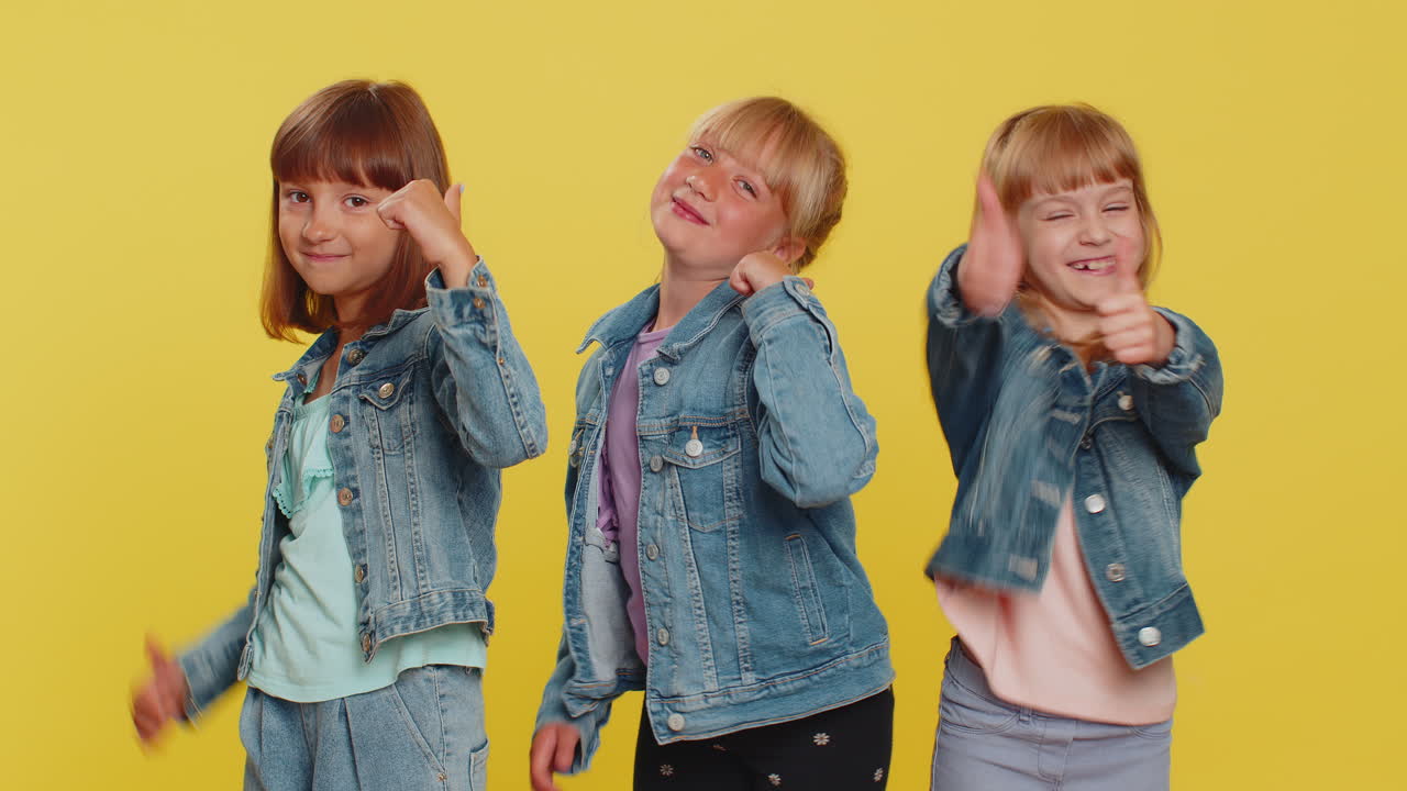 Teenage three girls raises thumbs up agrees gives positive reply like gesture good feedback