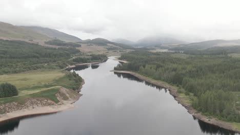 Flying-over-Laggan-Dam,-located-on-the-River-Spean-south-west-of-Loch-Laggan-in-the-scottish-highlands