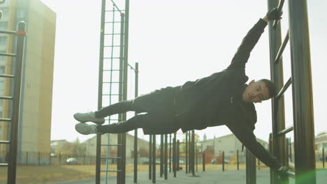 athlete doing human flag at workout playground