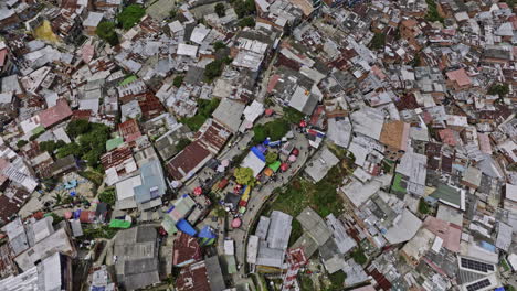 Medellin-Colombia-Aerial-v30-vertical-birds-eye-view,-flyover-famous-covered-escalators-capturing-hillside-Comuna-13,-tilt-up-reveals-San-Javier-cityscape---Shot-with-Mavic-3-Cine---November-2022