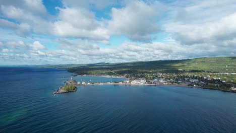 drone aerial view of a shoreline with fast moving clouds