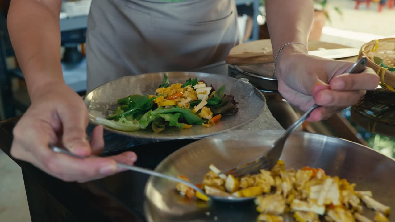 A Thai chef prepares fresh Thai spring rolls, showcasing traditional cooking techniques, fresh ingredients, and authentic Thai cuisine