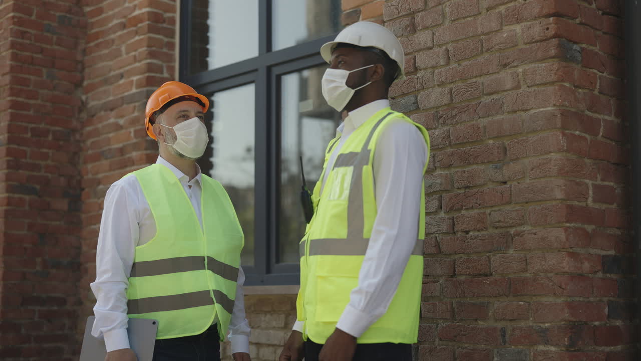 Construction Workers Discussing on a Building Site