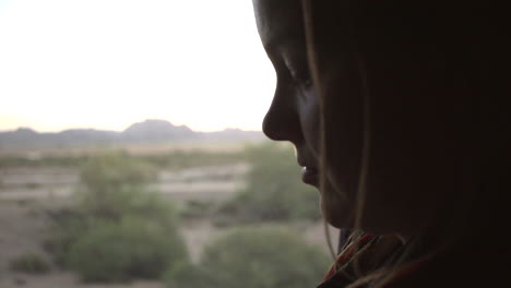 silhouette of woman sitting next to a window in a moving train