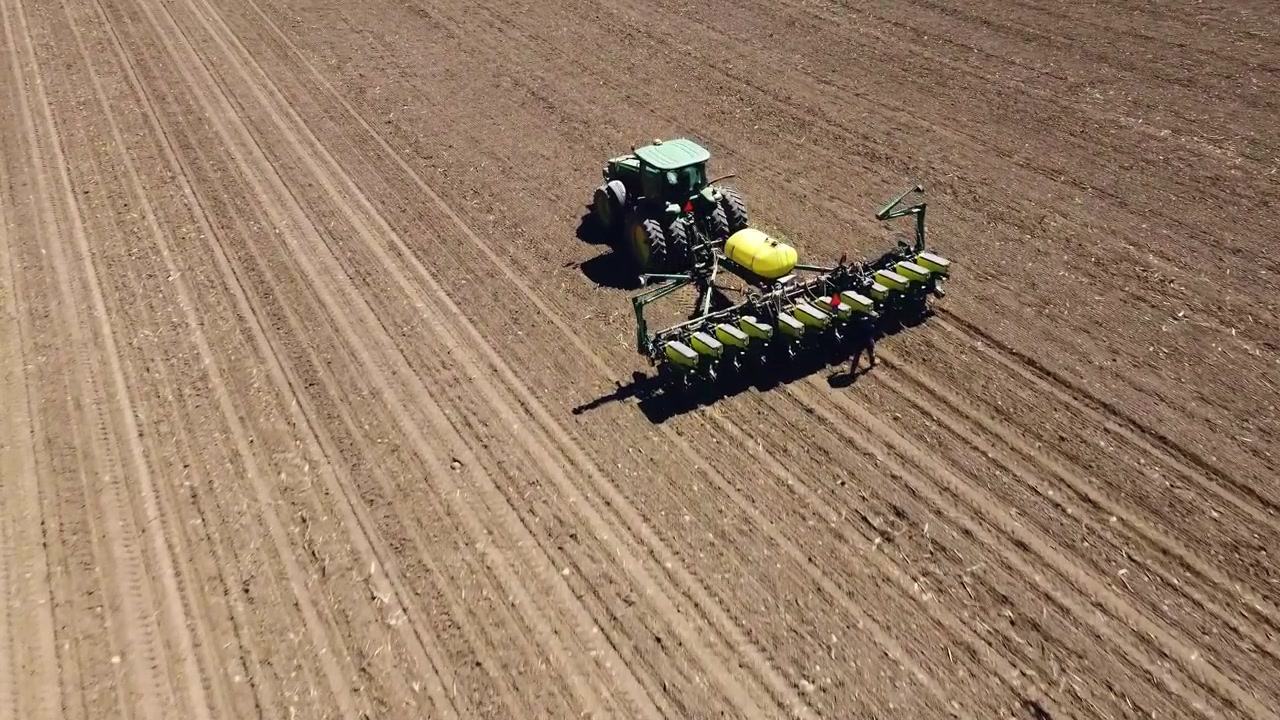 Trattore articolato John Deere 9400 che ara il terreno prima della semina