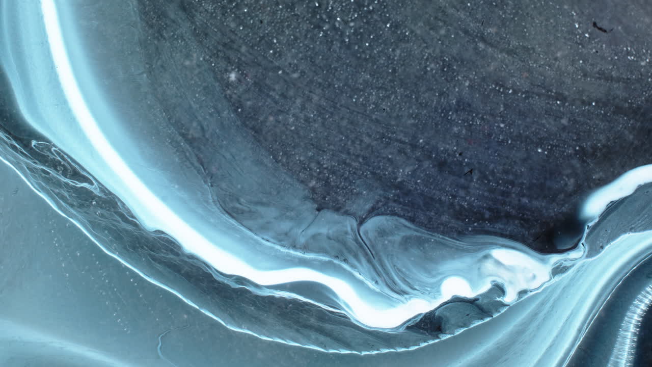 Macro shot of substances mixing with fluid and smooth textures