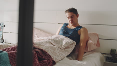 Transgender-Man-Waking-Up-in-Bed-and-Using-Smartphone