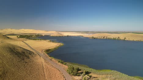 aerial view of serene lake and rolling hills