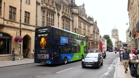 green bus passing through oxford town hall area